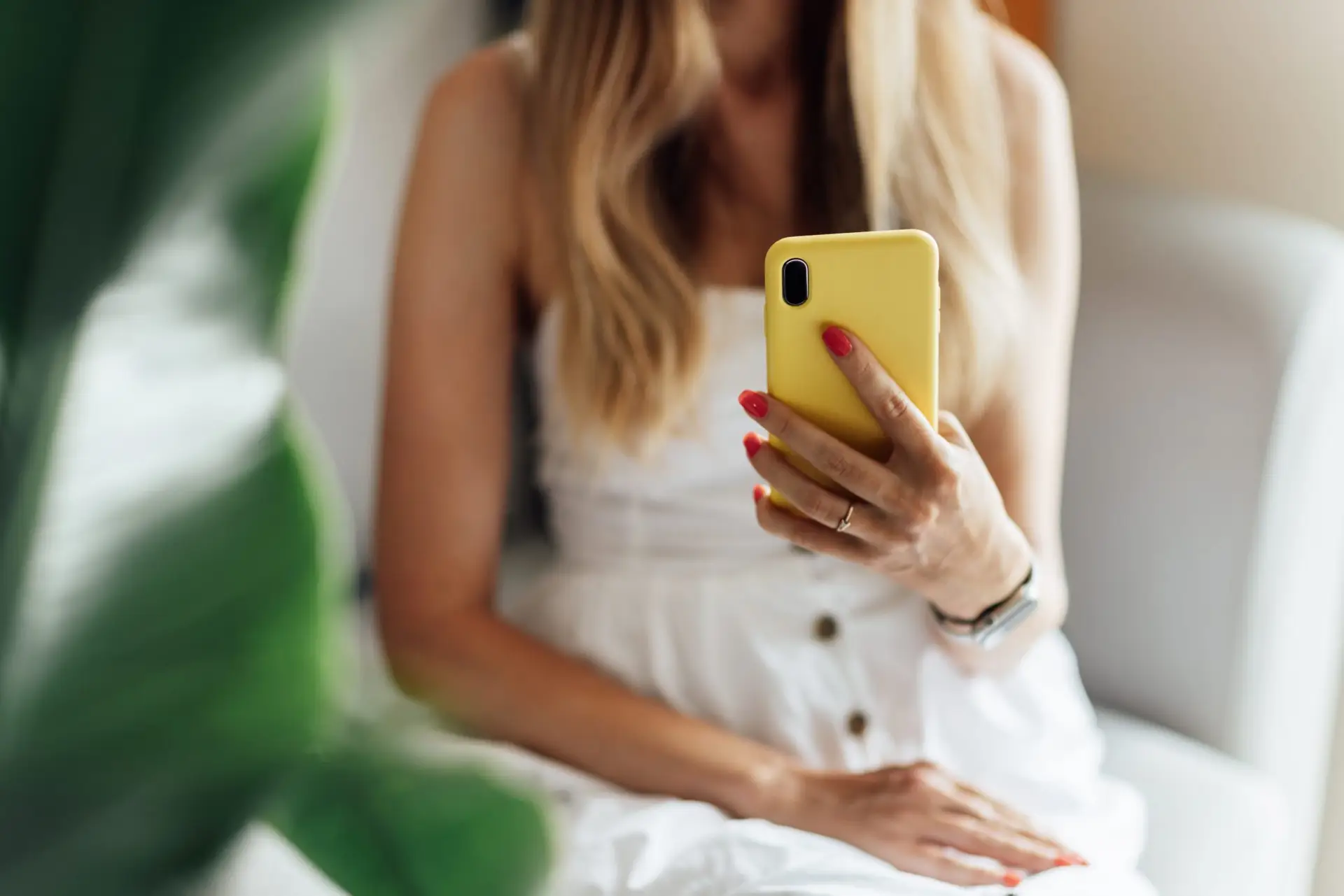 Young woman blogger using mobile phone, texting on smartphone app, searching or social networks